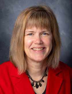 Photo of Dr. Karen Burg in a red blazer